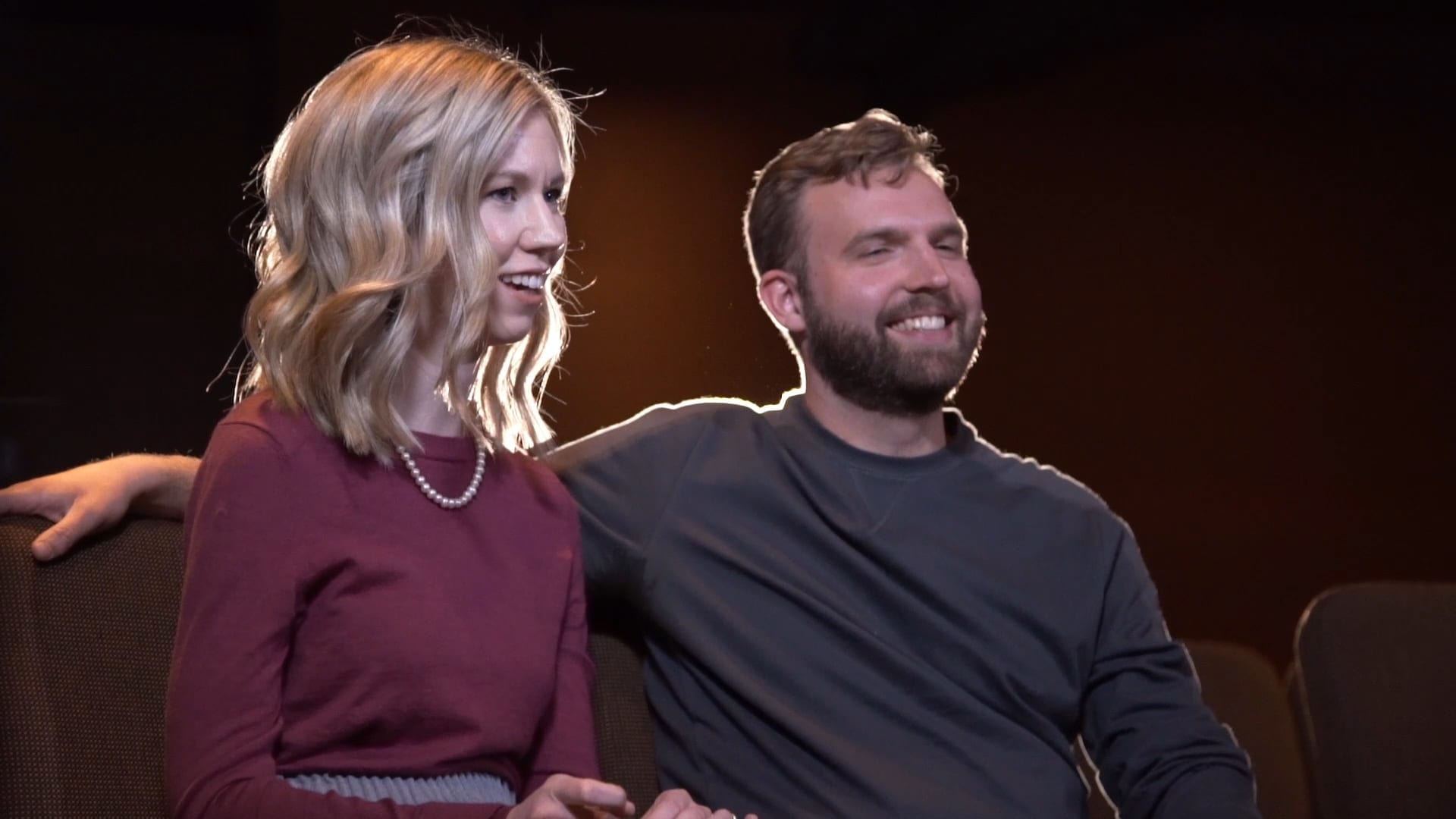 Two people sitting and smiling