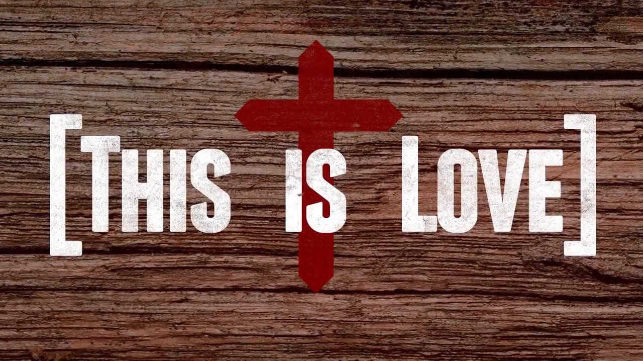 This is love. Image a of a cross on a piece of wood.